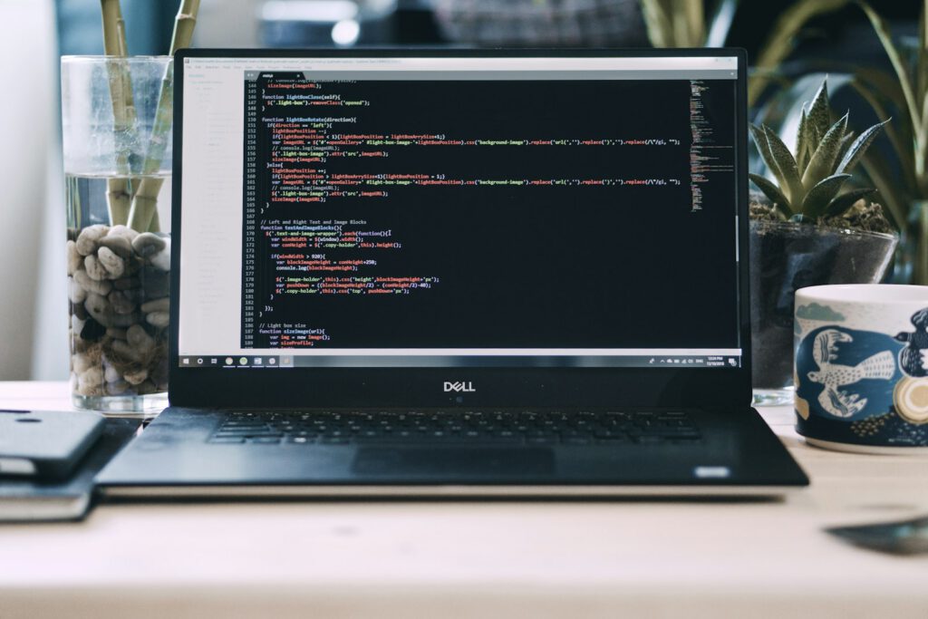 Code affiché sur un ordinateur portable dans un bureau – illustration de l’article « Ionia Web lance son offre « site + impression » pour les créateurs d’entreprise », blog Ionia Web